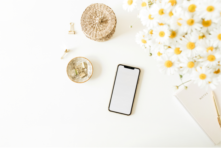 notes + smartphone + flowers at table